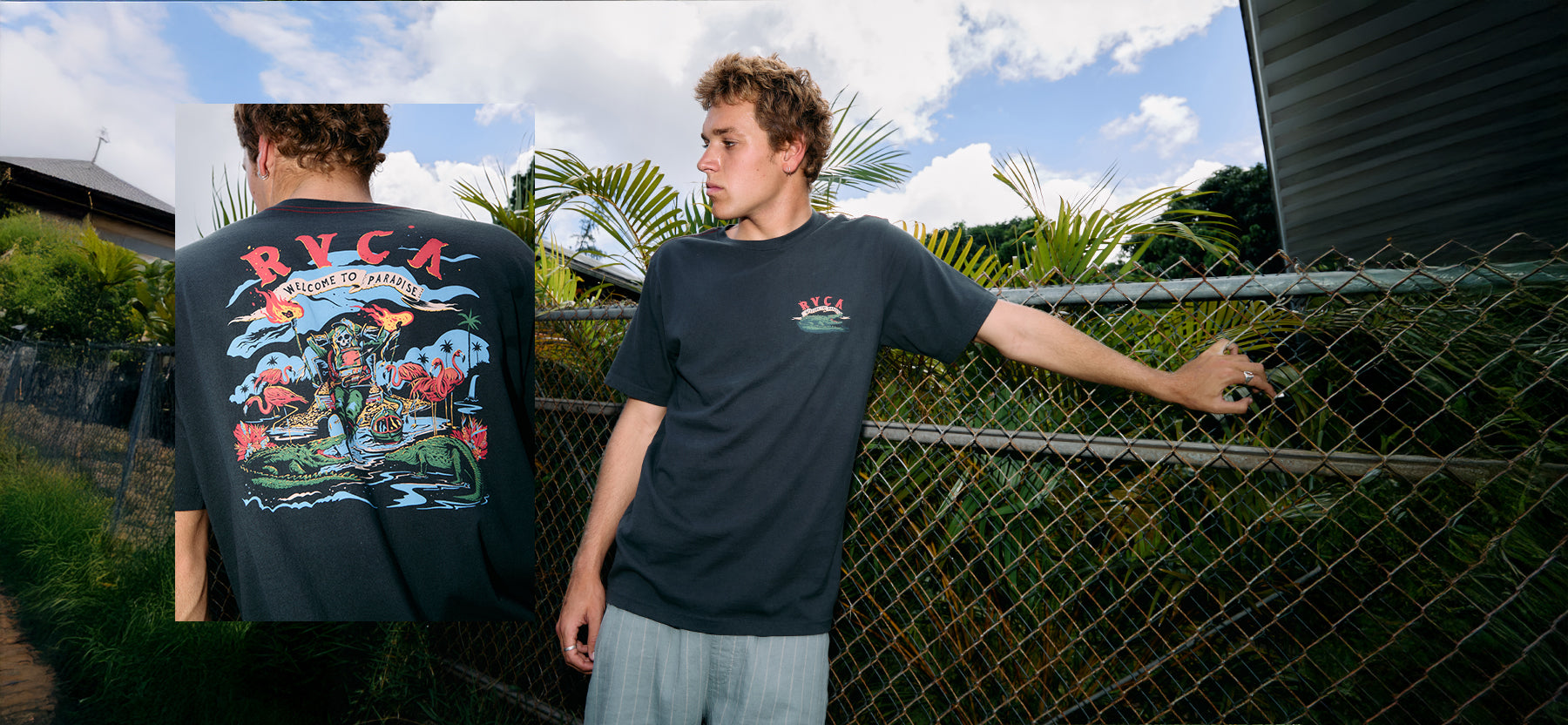 Person wearing a black t-shirt with colorful graphics and text, standing outdoors.