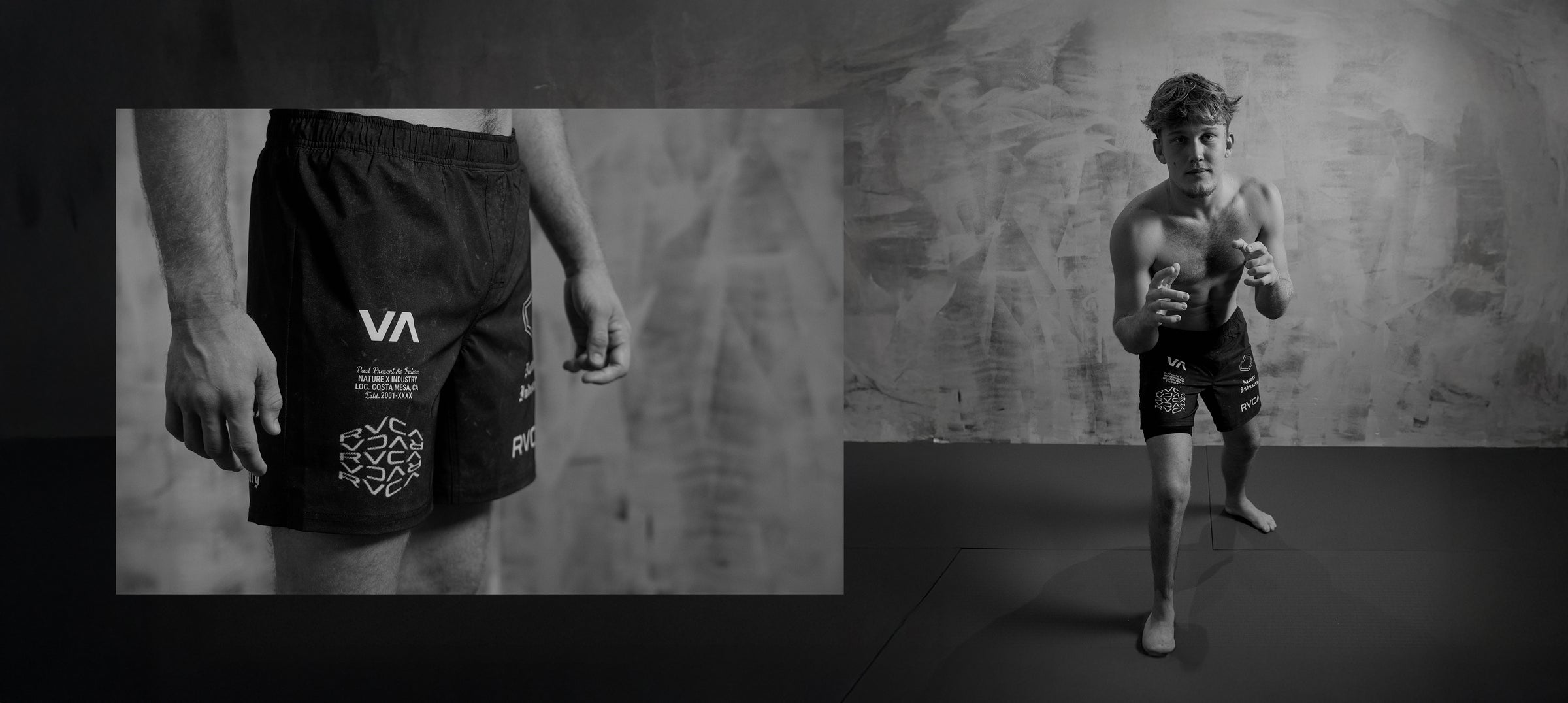 Person wearing black shorts with a brand logo, standing against a textured wall.