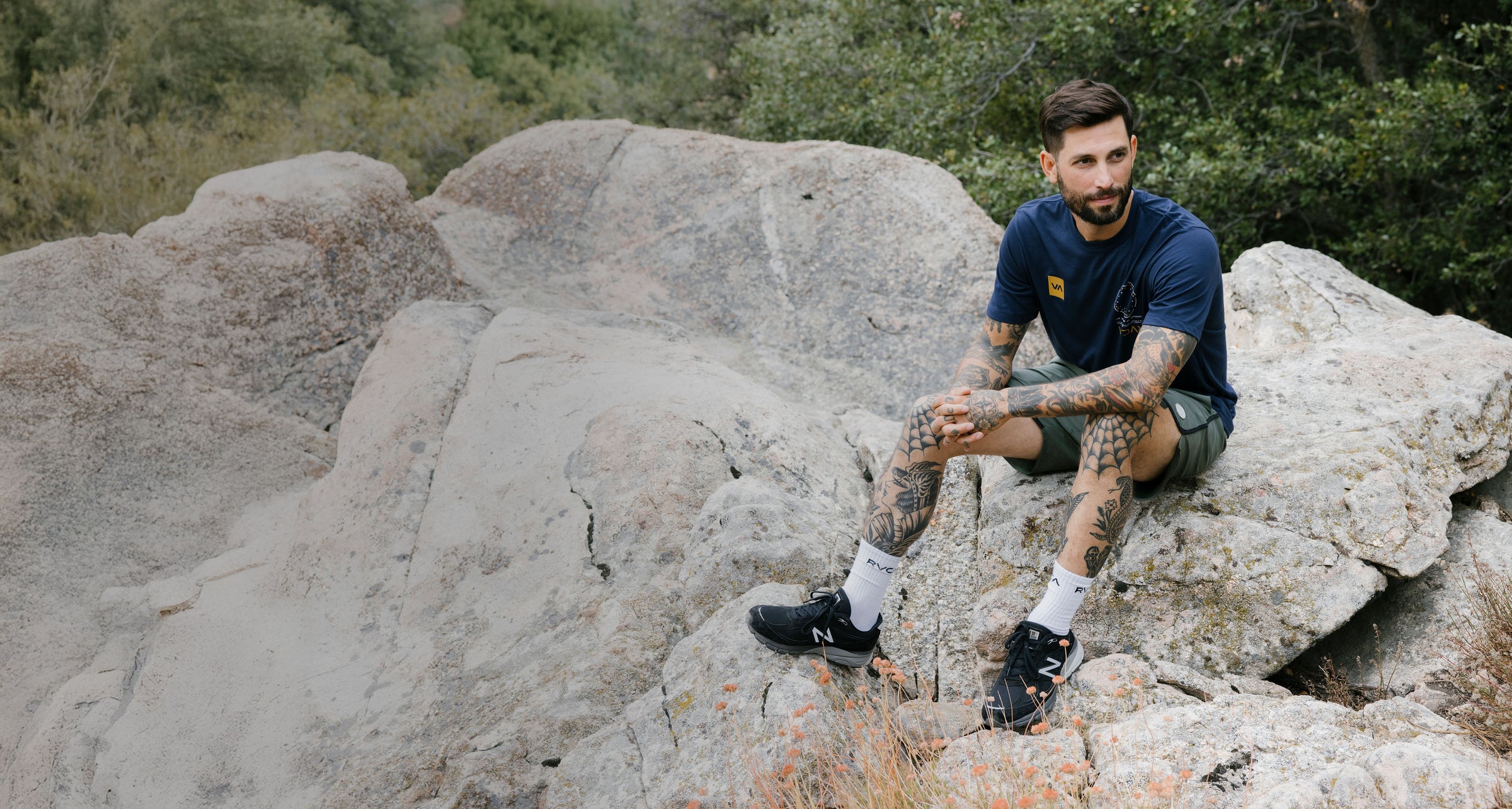 Man sitting on a rock with a natural landscape background