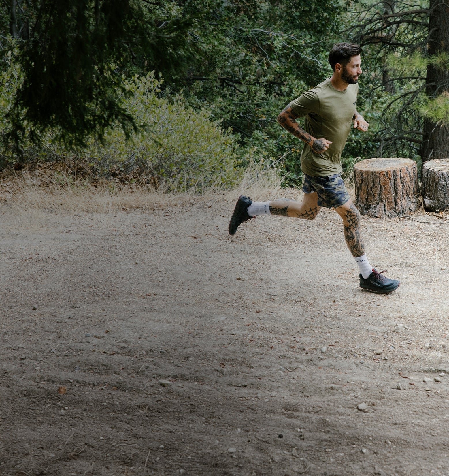 Man running on a dirt path in a forest