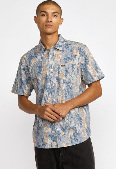 Man wearing a patterned shirt on a white background